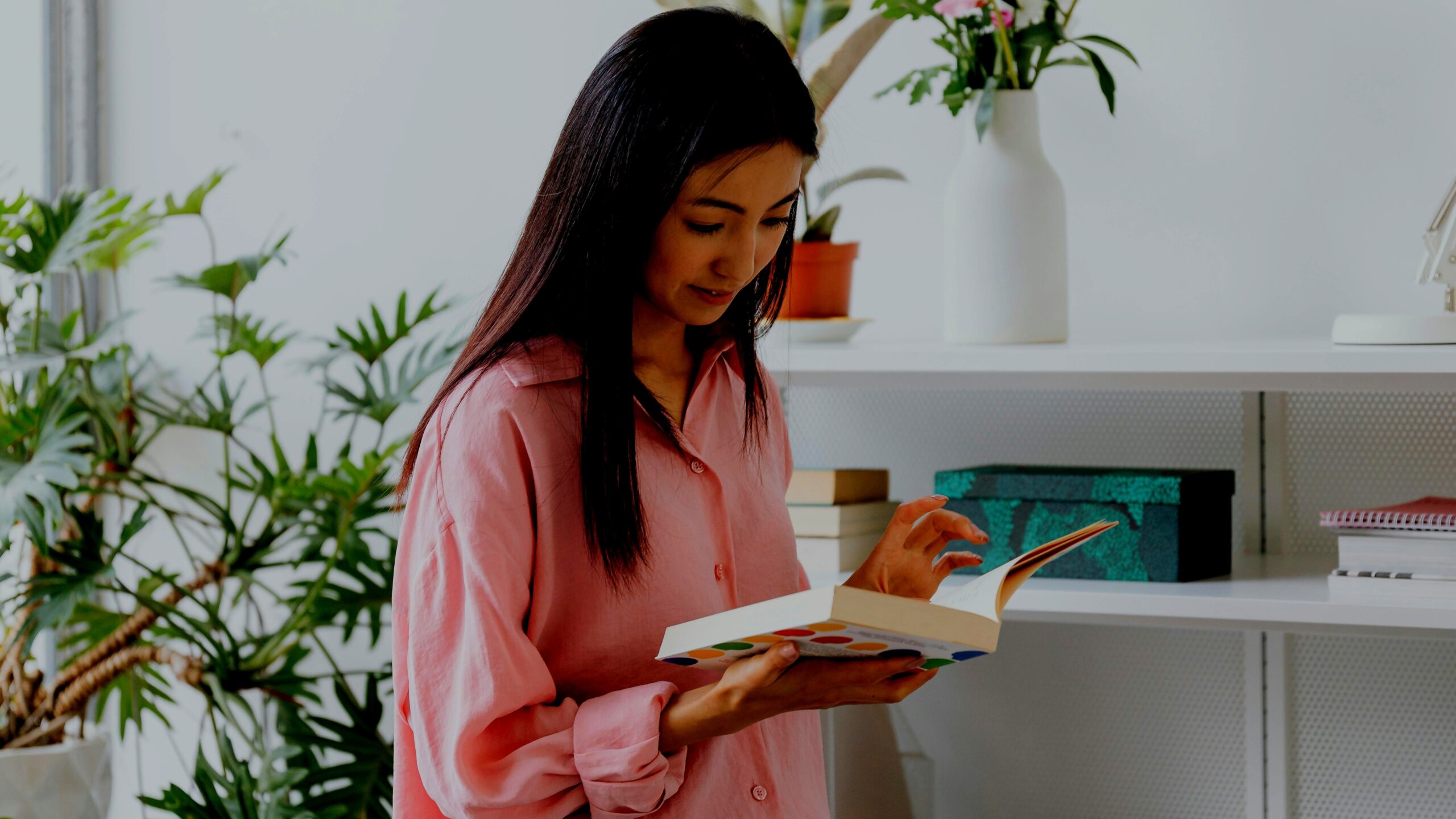 Stack of personal growth books for women on a wooden table with a coffee cup